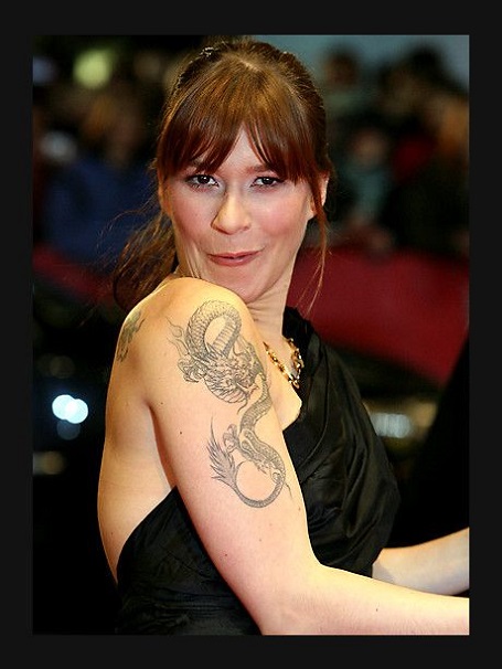 The Japanese Dragon tattoo on her upper right arm the most conspicuous and her favorite tattoo